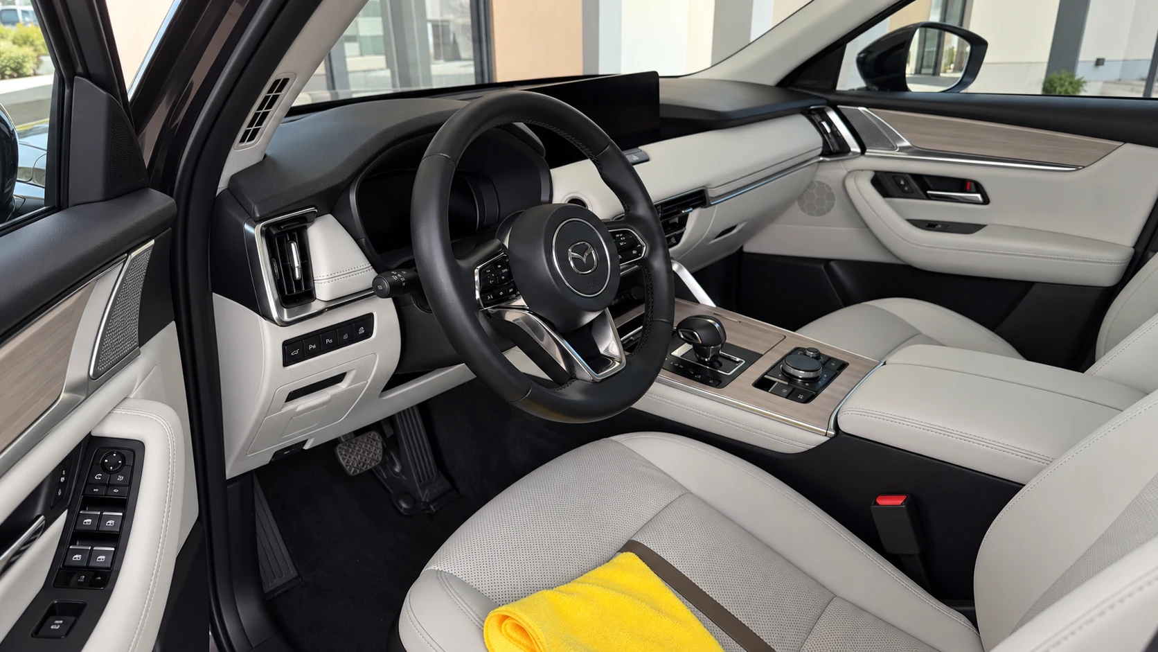 Tablero, volante y asientos claros de una Mazda CX-90 con el interior impecable